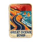 Great Ocean Road embroidered travel patch with the Twelve Apostles sea stacks beside the ocean; photographed on a transparent background.