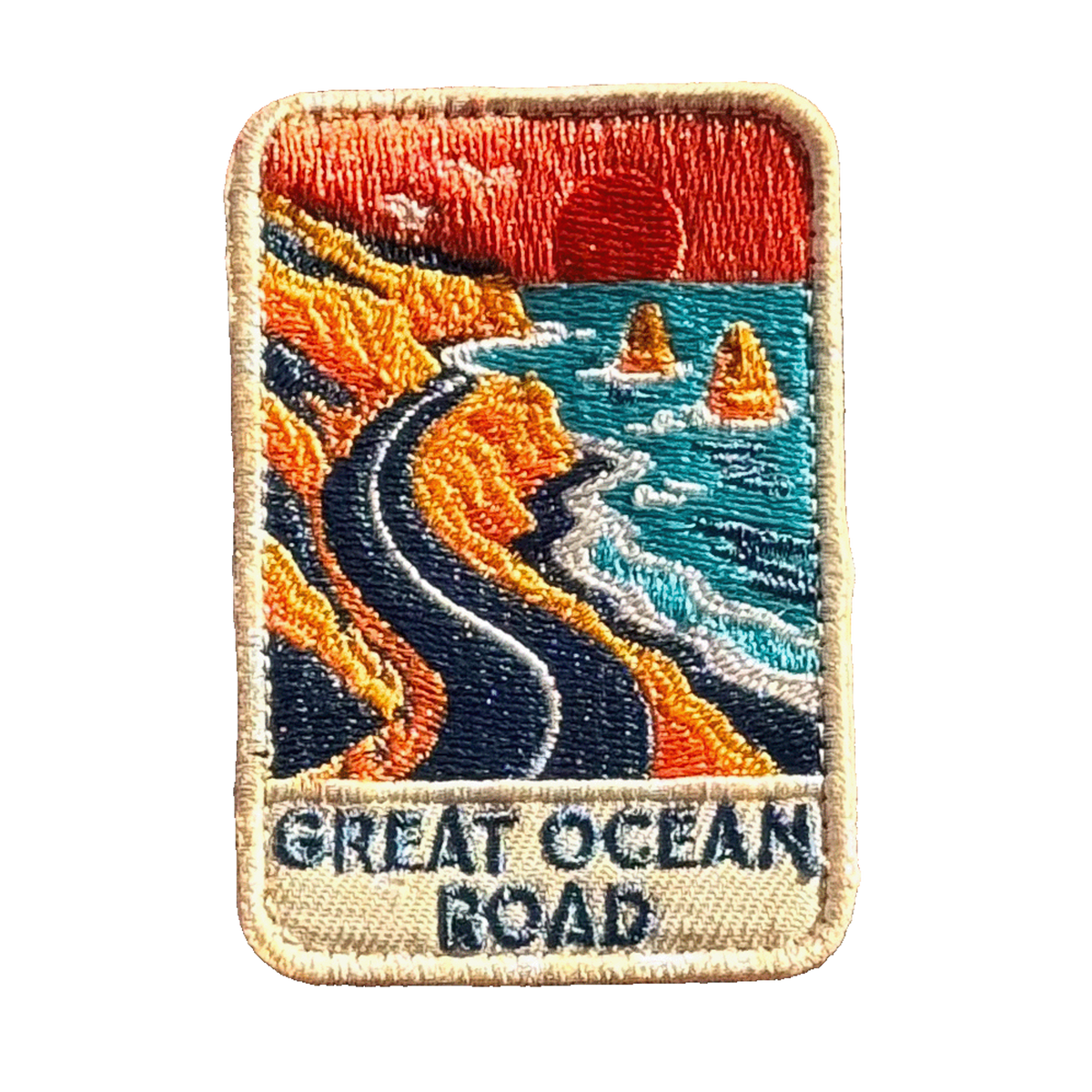 Great Ocean Road embroidered travel patch with the Twelve Apostles sea stacks beside the ocean; photographed on a transparent background.