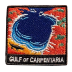 Gulf of Carpentaria embroidered travel patch with a barramundi and tropical coastline; photographed on a transparent background.