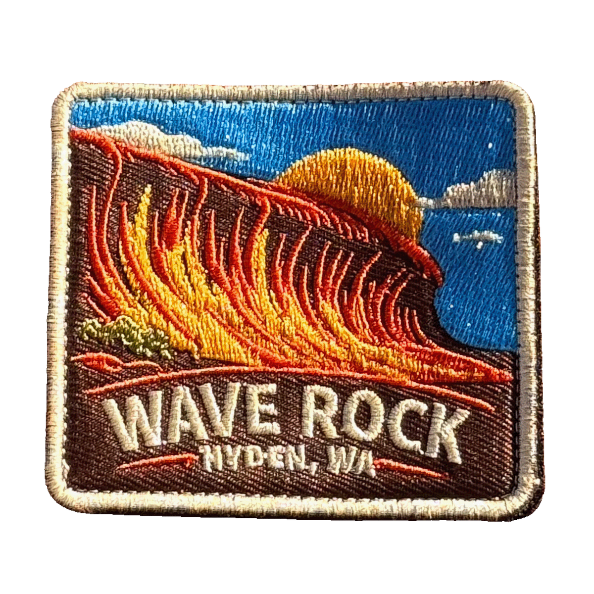 Hyden - Wave Rock embroidered travel patch with the curved rock formation of Wave Rock; photographed on a transparent background.
