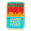 James Price Point embroidered travel patch with layered red coastal cliffs, turquoise water and a dark green treeline; photographed on a transparent background.