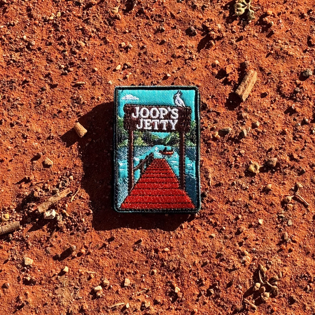 Joop's Jetty - Harrietville embroidered travel patch with a wooden jetty and Joop‚Äôs Jetty sign above a lake with a canoe.