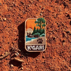 K'gari - Fraser Island embroidered travel patch with a shipwreck on the beach, a dingo paw print and green coastal forest.