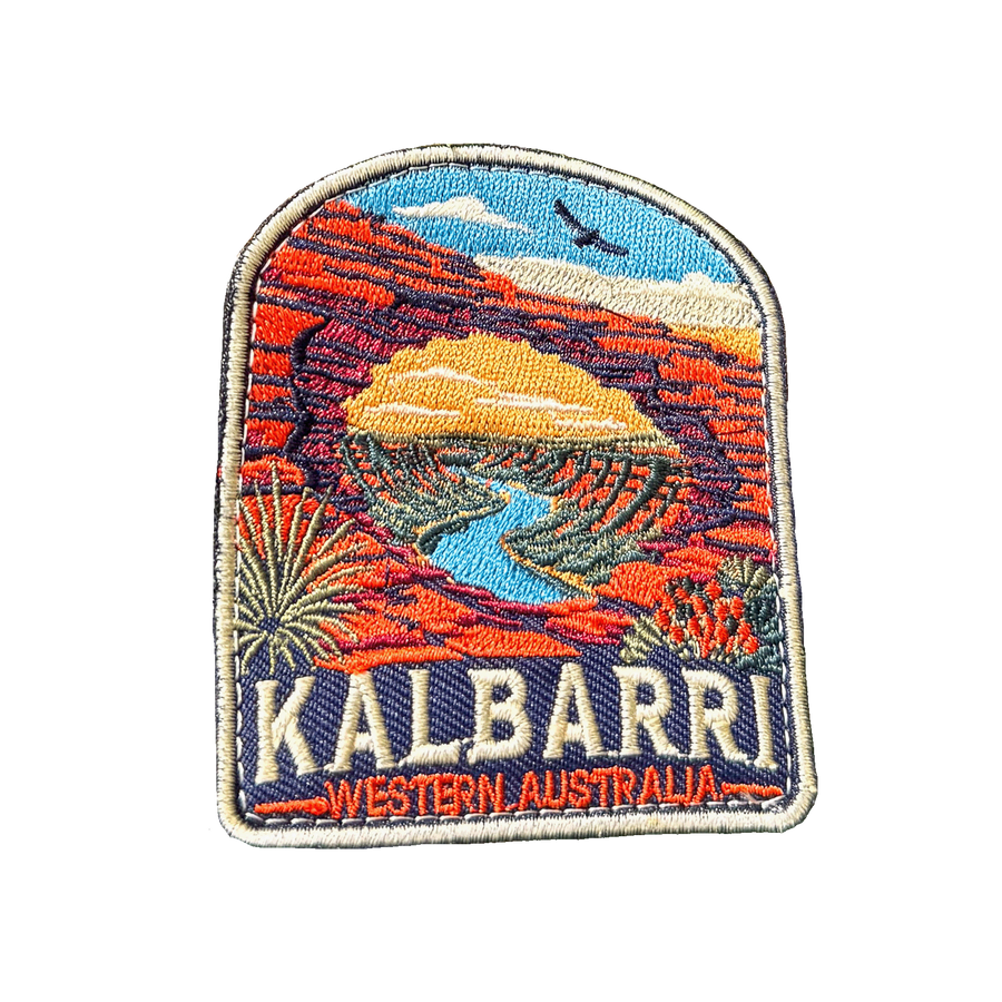 Kalbarri embroidered travel patch with a red sandstone arch framing a winding river through an outback gorge; photographed on a transparent background.