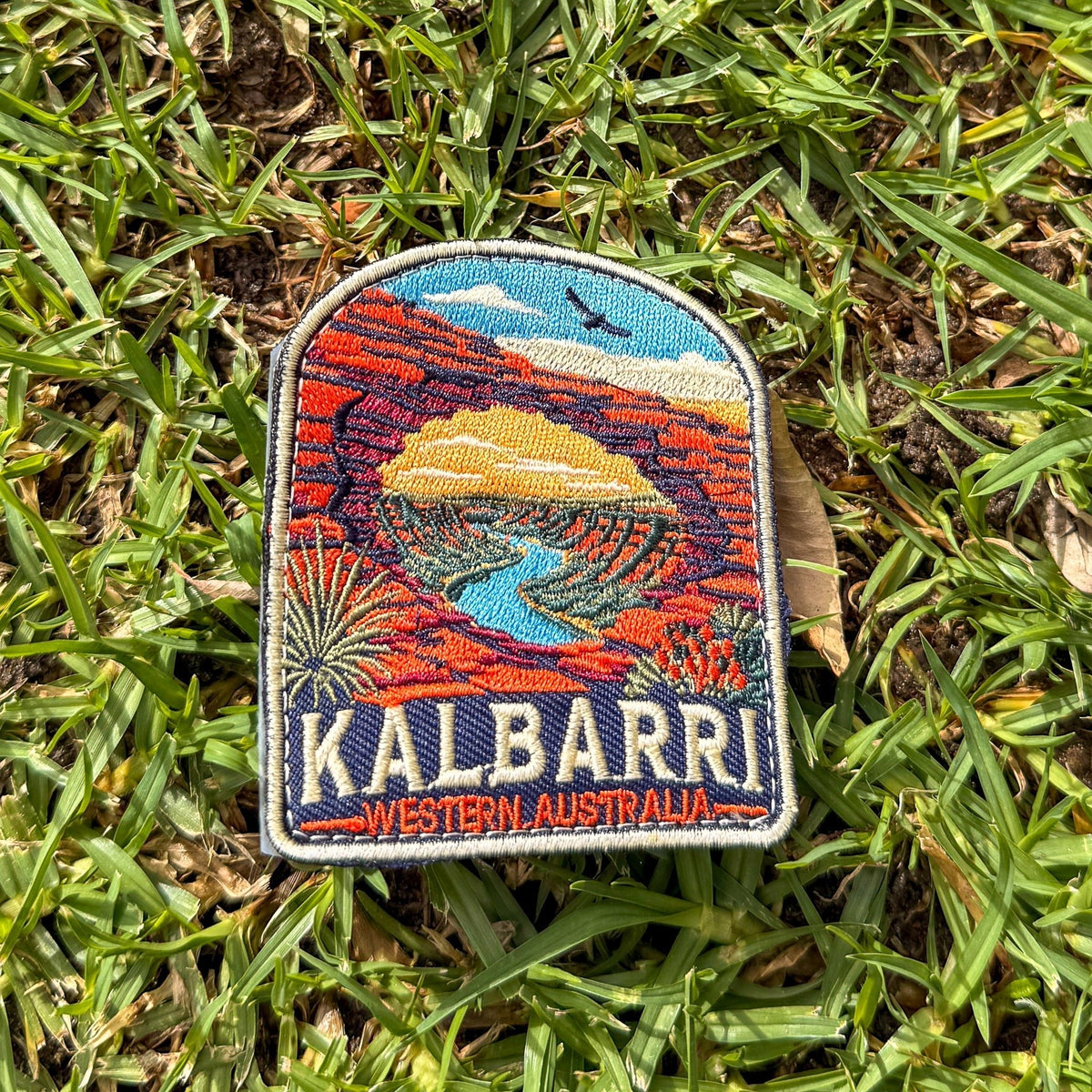 Kalbarri embroidered travel patch with a red sandstone arch framing a winding river through an outback gorge.