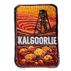 Kalgoorlie embroidered travel patch with a mining headframe above golden nuggets against red outback hills; photographed on a transparent background.