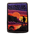 Katherine Gorge (Nitmiluk) embroidered travel patch with a hiker silhouetted against an orange sunset and gorge cliffs at Nitmiluk National Park; photographed on a transparent background.