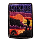 Katherine Gorge (Nitmiluk) embroidered travel patch with a hiker silhouetted against an orange sunset and gorge cliffs at Nitmiluk National Park; photographed on a transparent background.