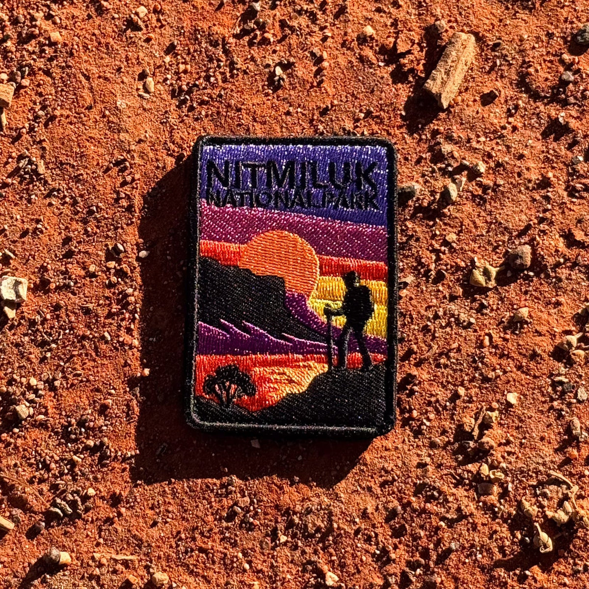 Katherine Gorge (Nitmiluk) embroidered travel patch with a hiker silhouetted against an orange sunset and gorge cliffs at Nitmiluk National Park.