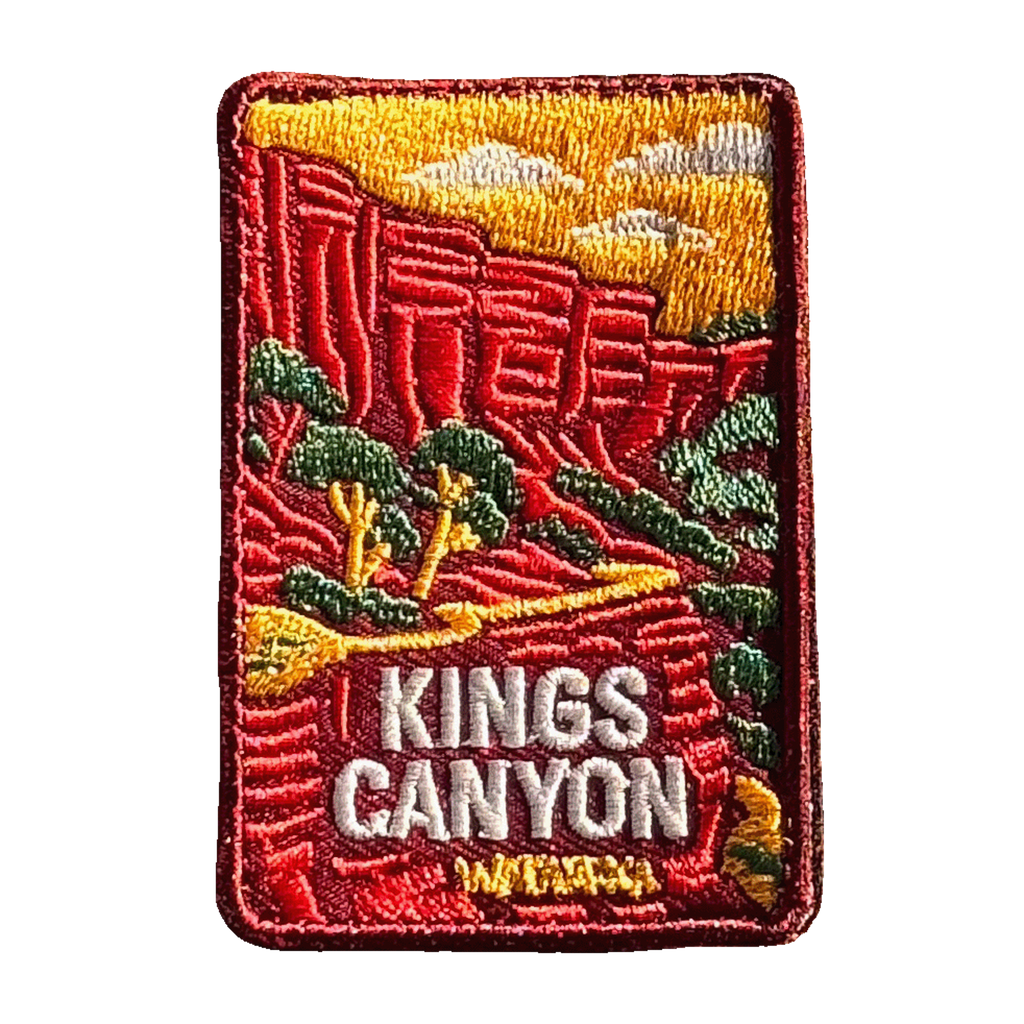 Kings Canyon (Watarrka) embroidered travel patch with red sandstone canyon walls and trees in Watarrka National Park; photographed on a transparent background.