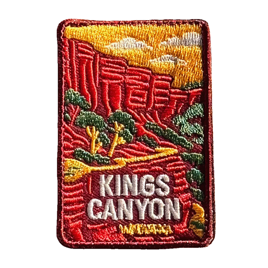 Kings Canyon (Watarrka) embroidered travel patch with red sandstone canyon walls and trees in Watarrka National Park; photographed on a transparent background.