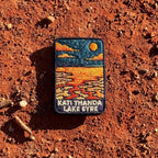 Lake Eyre (Kati Thanda) embroidered travel patch with cracked salt flats and shallow water beneath an orange sun at Kati Thanda‚ÄìLake Eyre.
