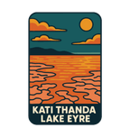 Lake Eyre (Kati Thanda) illustrated travel patch design featuring cracked salt flats and shallow water beneath an orange sun at Kati Thanda‚ÄìLake Eyre.