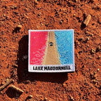 Lake MacDonnell embroidered travel patch with an aerial view of a road separating bright pink and blue lakes.