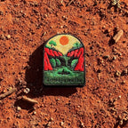 Lawn Hill (Boodjamulla) embroidered travel patch with a person canoeing through a green river between red cliffs at Boodjamulla.