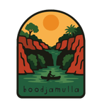Lawn Hill (Boodjamulla) illustrated travel patch design featuring a person canoeing through a green river between red cliffs at Boodjamulla.