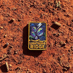 Lightning Ridge embroidered travel patch with colourful opals, lightning and a small mining shack beneath a dark sky.