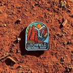 Litchfield National Park embroidered travel patch with red termite mounds, a waterfall and rocky scenery in Litchfield National Park.