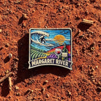 Margaret River embroidered travel patch with a surfer riding a wave above vineyard rows, grapes and a wine glass.