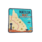 Matilda Way embroidered travel patch with a Queensland route map from Barringun to Kurumba, with a windmill, cattle and a boat; photographed on a transparent background.