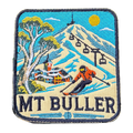 Mount Buller embroidered travel patch with a skier descending a snowy slope beneath chairlifts and a mountain village; photographed on a transparent background.