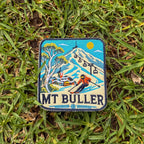Mount Buller embroidered travel patch with a skier descending a snowy slope beneath chairlifts and a mountain village.