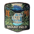 Mount Field National Park embroidered travel patch with a tiered waterfall surrounded by lush green forest; photographed on a transparent background.