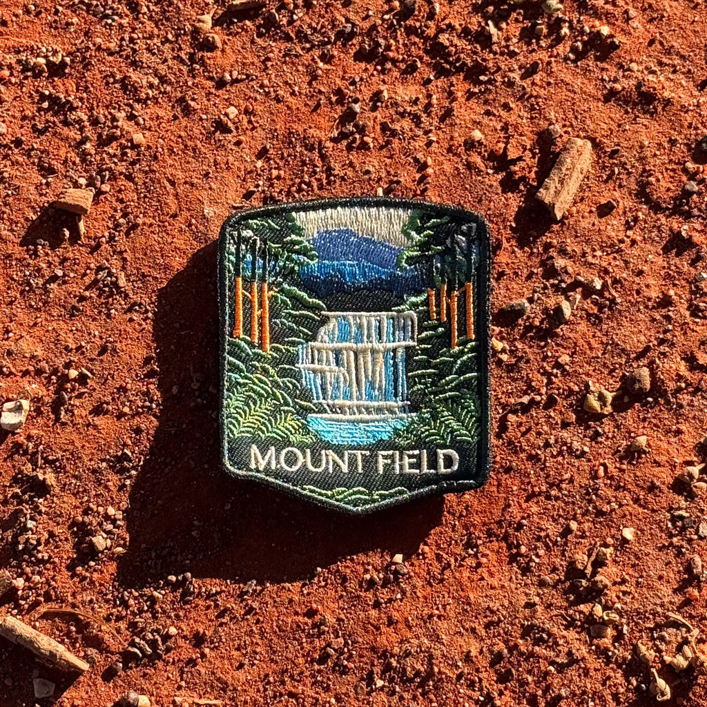 Mount Field National Park embroidered travel patch with a tiered waterfall surrounded by lush green forest.