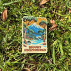 Mount Kosciouzko embroidered travel patch with a snow-covered mountain, alpine cabin, trees and a horse.