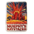 Murphys Haystacks embroidered travel patch with large rounded granite boulders in golden grass beneath a radiant sunset; photographed on a transparent background.