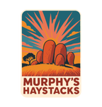 Murphys Haystacks illustrated travel patch design featuring large rounded granite boulders in golden grass beneath a radiant sunset.