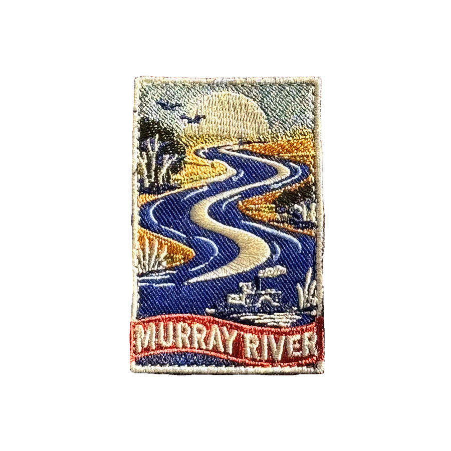 Murray River embroidered travel patch with a winding blue river with a paddle steamer, birds and riverbank trees; photographed on a transparent background.