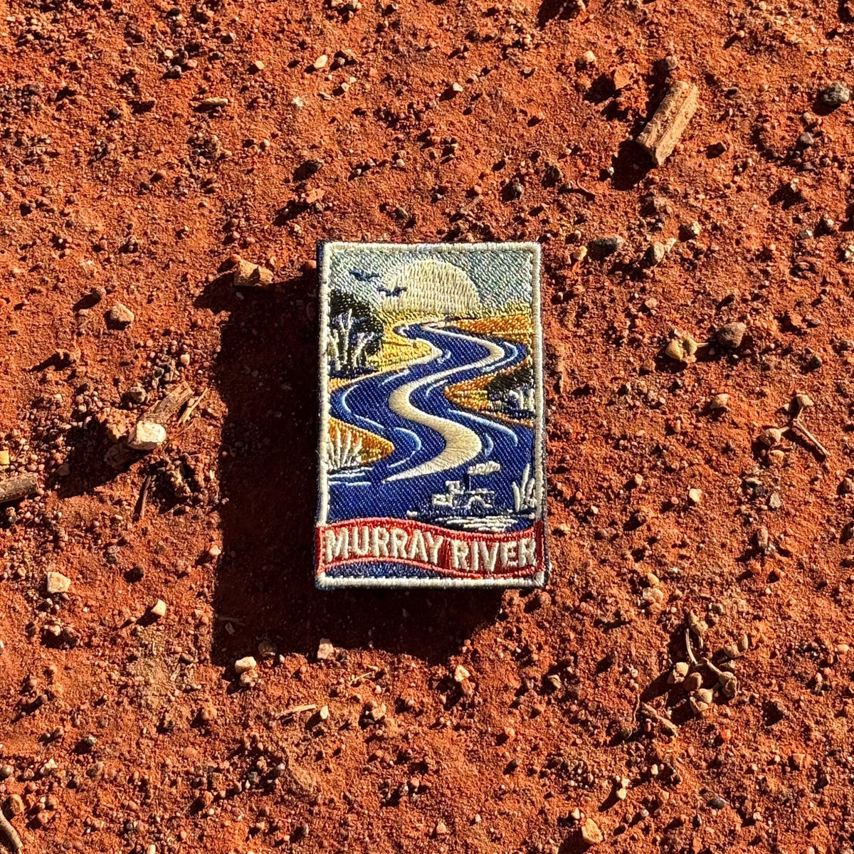 Murray River embroidered travel patch with a winding blue river with a paddle steamer, birds and riverbank trees.