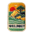 Nhulunbuy - Arnhem Land embroidered travel patch with a rocky tropical shoreline with trees, gentle waves and a setting sun; photographed on a transparent background.