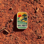Nhulunbuy - Arnhem Land embroidered travel patch with a rocky tropical shoreline with trees, gentle waves and a setting sun.