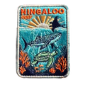 Ningaloo Reef embroidered travel patch with a whale shark, manta ray and sea turtle swimming over coral reef; photographed on a transparent background.