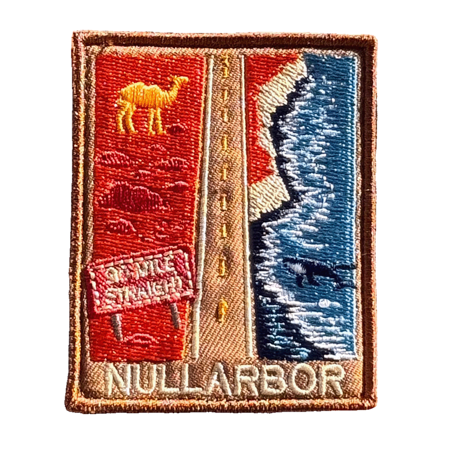 Nullarbor Plain embroidered travel patch with the 90 Mile Straight road between red desert with a camel and coastal cliffs with a whale; photographed on a transparent background.