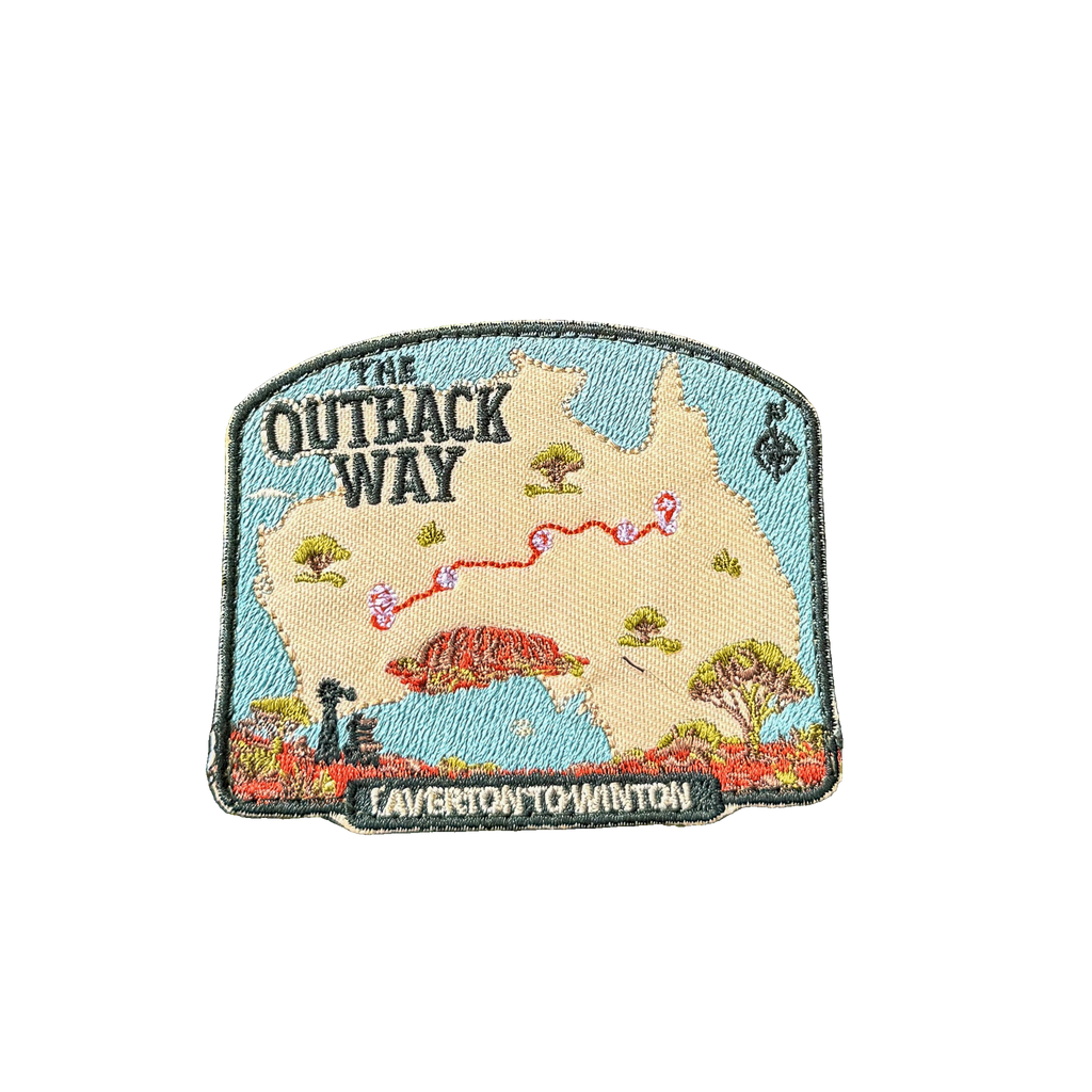 Outback Way embroidered travel patch with a map of Australia showing the Laverton to Winton route and Uluru; photographed on a transparent background.