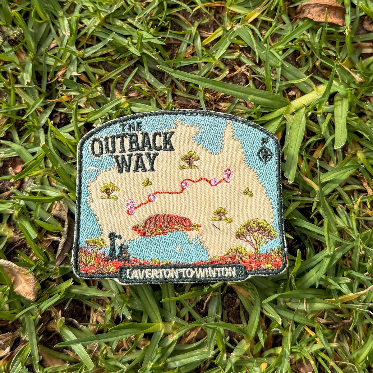 Outback Way embroidered travel patch with a map of Australia showing the Laverton to Winton route and Uluru.