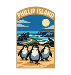 Phillip Island illustrated travel patch design featuring three little penguins on a beach with a motorcycle racer and ocean cliffs behind.