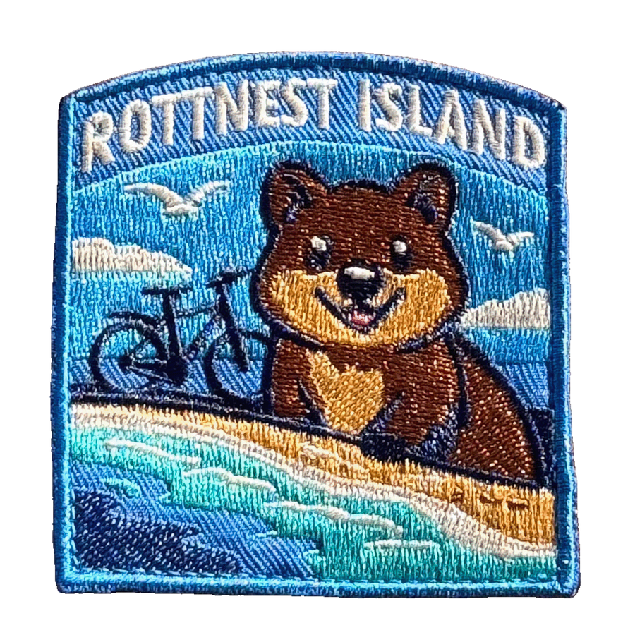 Rottnest Island embroidered travel patch with a quokka and an island beach with turquoise water; photographed on a transparent background.
