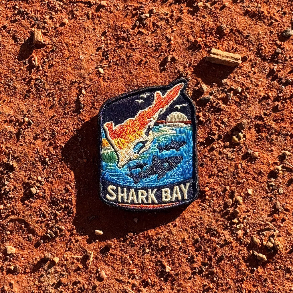 Shark Bay embroidered travel patch with a marine coastline with turquoise water and sea life.