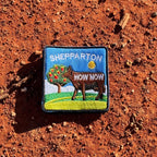 Shepparton embroidered travel patch with a colourful cow sculpture in a regional landscape.