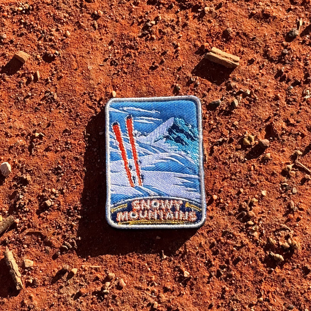 Snowy Mountains embroidered travel patch with snow-covered alpine peaks.