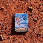 Snowy Mountains embroidered travel patch with snow-covered alpine peaks.