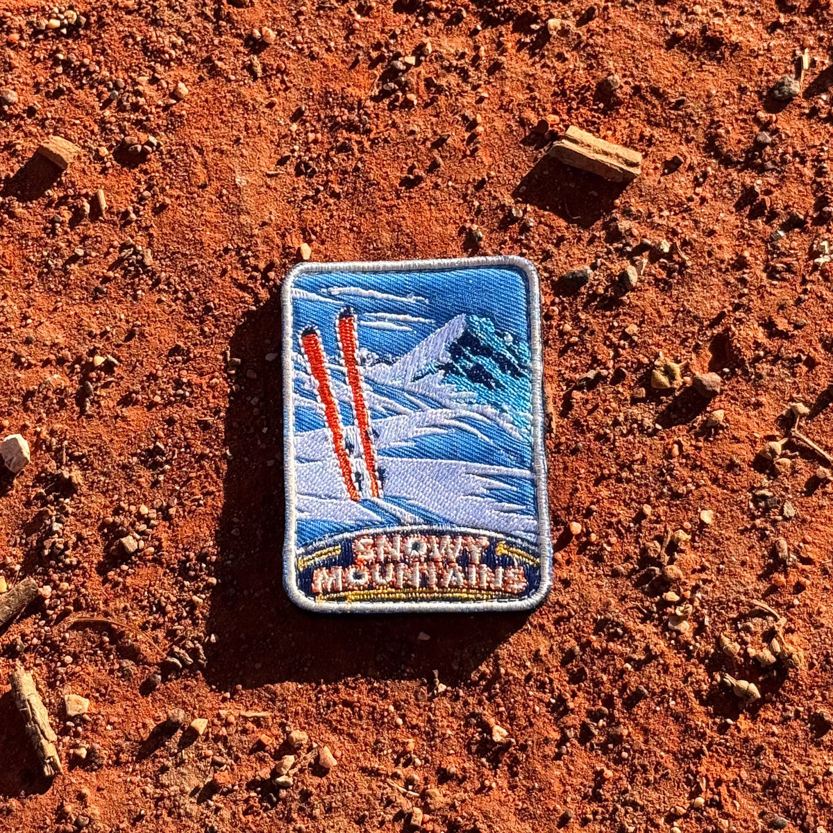 Snowy Mountains embroidered travel patch with snow-covered alpine peaks.