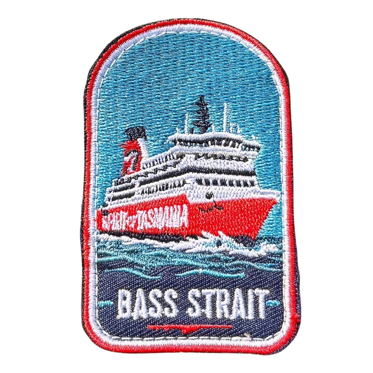 Spirit of Tasmania - Bass Strait embroidered travel patch featuring red and white Spirit of Tasmania ferry sailing through dark blue Bass Strait waves.