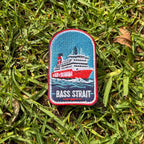 Spirit of Tasmania - Bass Strait embroidered travel patch featuring red and white Spirit of Tasmania ferry sailing through dark blue Bass Strait waves.