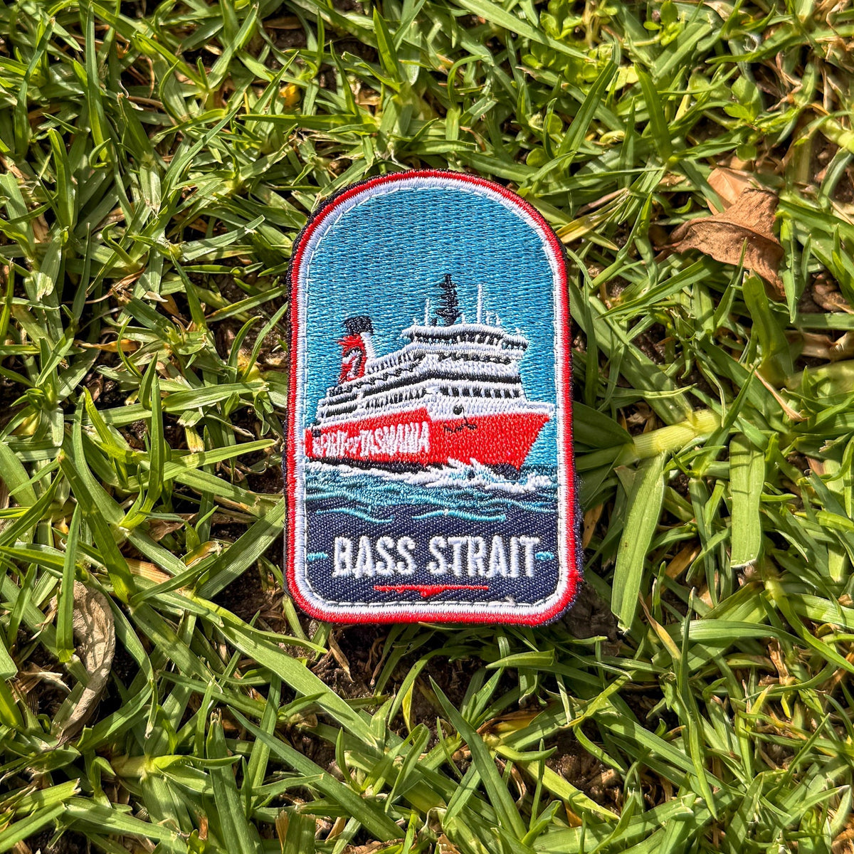Spirit of Tasmania - Bass Strait embroidered travel patch featuring red and white Spirit of Tasmania ferry sailing through dark blue Bass Strait waves.