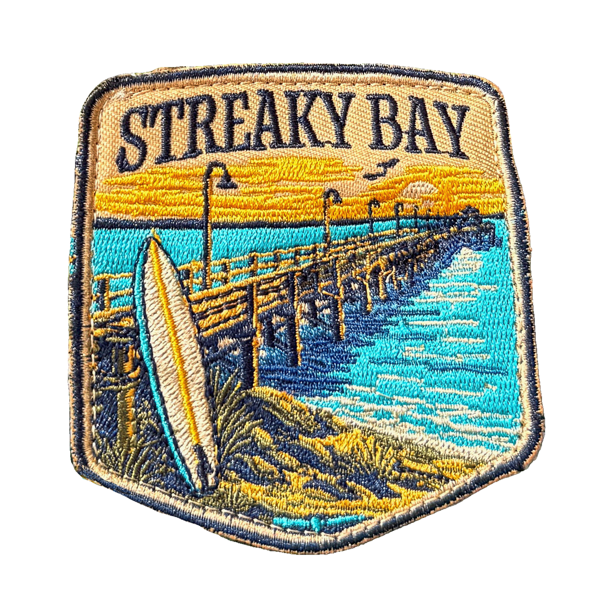 Streaky Bay embroidered travel patch with a sandy coastline and turquoise water; photographed on a transparent background.